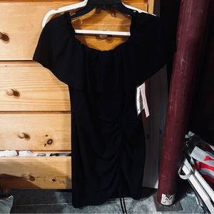 Never worn, slim fit black off the shoulder dress. Tags on